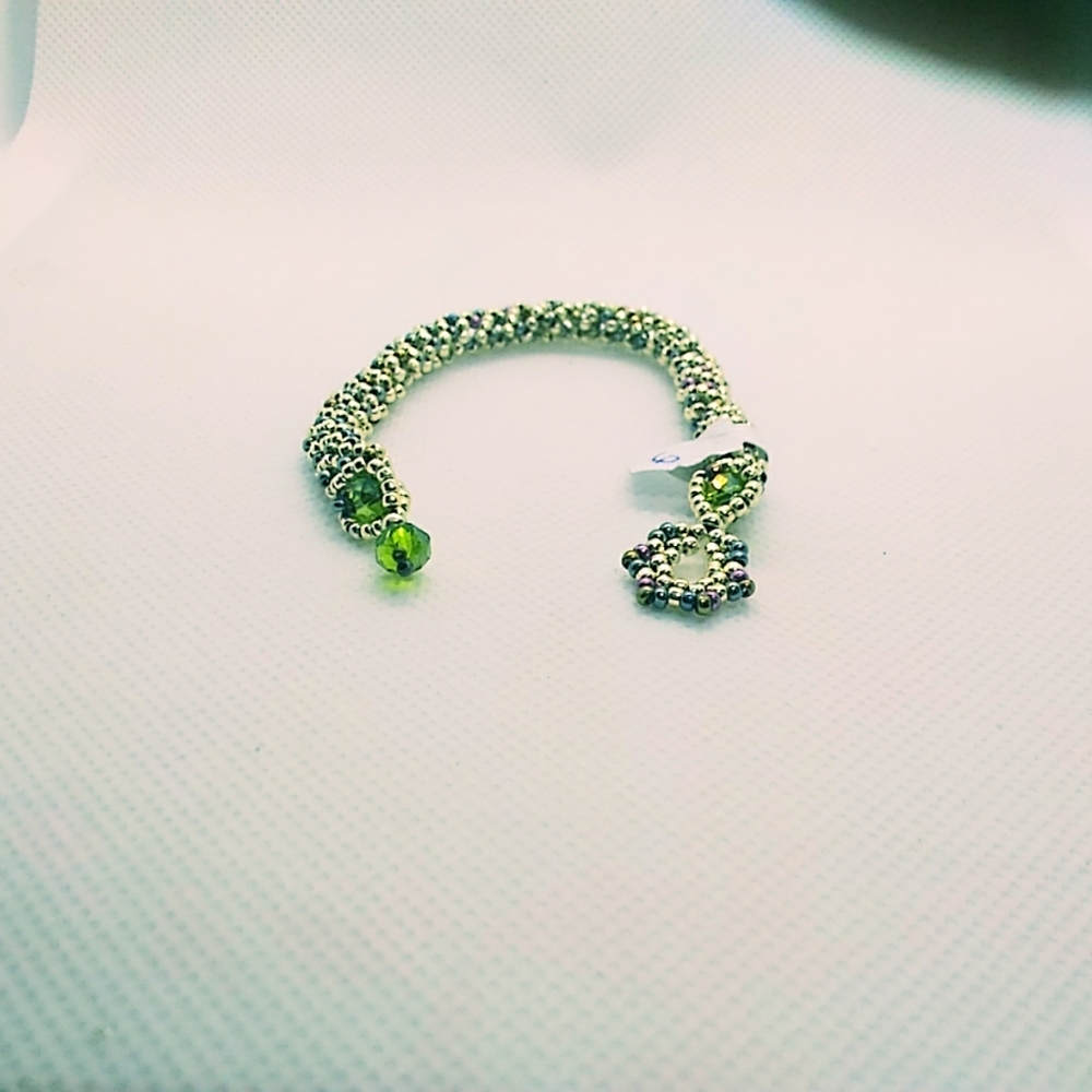Silver and green hand woven bracelet.